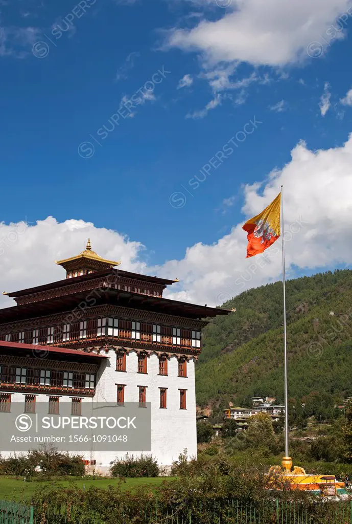 The Bhutanese national flag flutters at the seat of government Thimphu Dzong or Trashichhoe Dzong, Thimphu, Bhutan