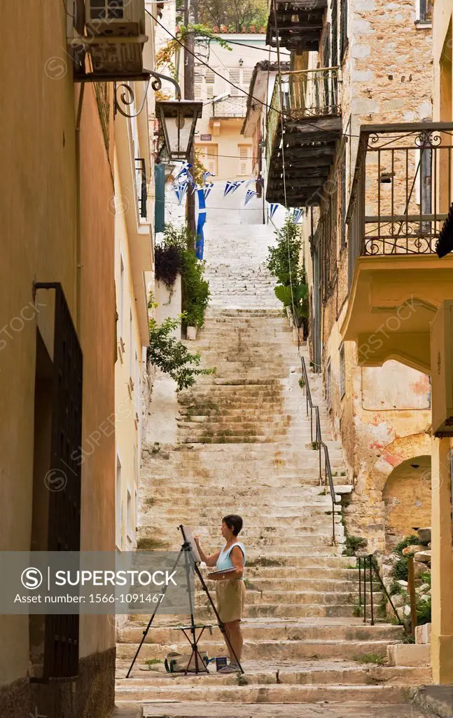 Pastel coloured balconied houses and steps are typical of the old town of Nafplio, Greece´s first capital after independence, Argolid, Peloponnese, Gr...