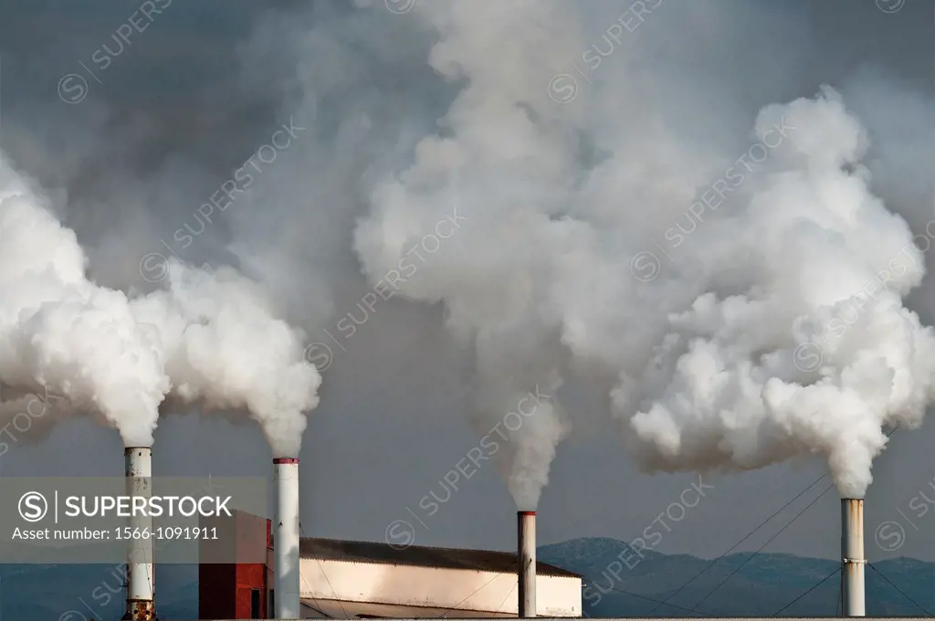 Smoking factory chimneys at Nafplio, Argolid, Peloponnese, Greece