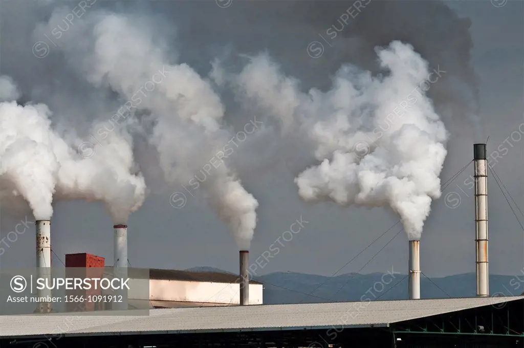 Smoking factory chimneys at Nafplio, Argolid, Peloponnese, Greece