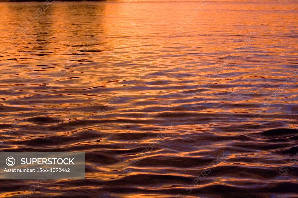 Ripples on water at sunset