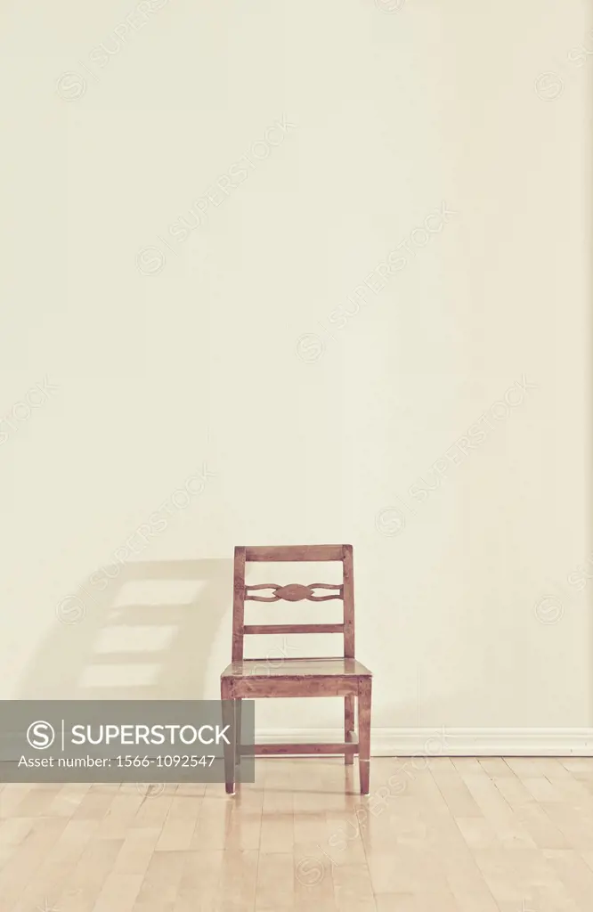 Empty chair in an empty room