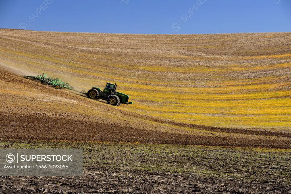 Farm tractor preparing Palouse farmland in spring  Washington