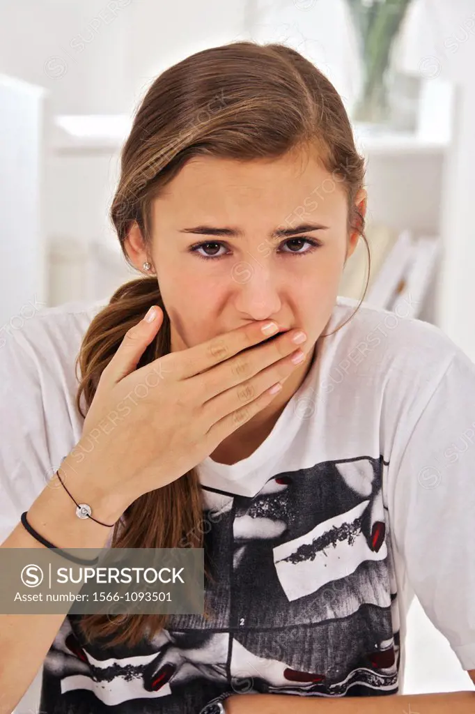Teenage girl putting her hand in front of her mouth : afraid, forgot something, belching, stomach problems, etc....
