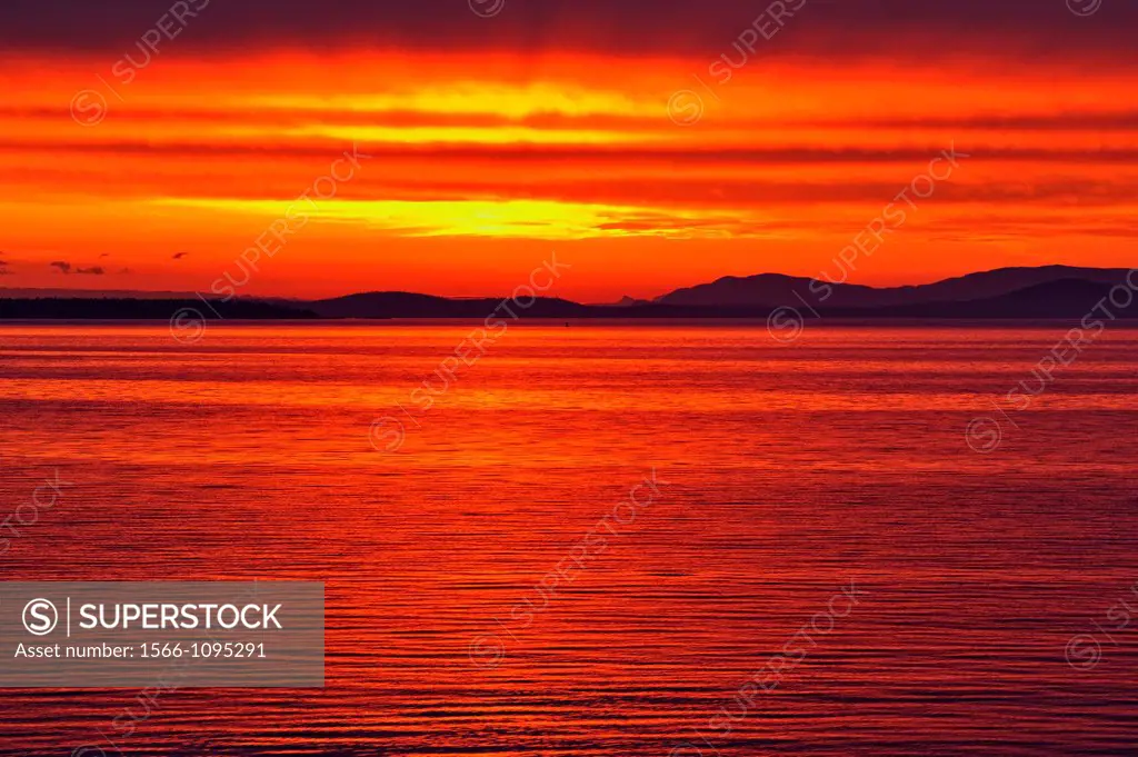 Dawn skies over Haro Strait and the San Juan Islands, Victoria Cordova Bay, BC, Canada