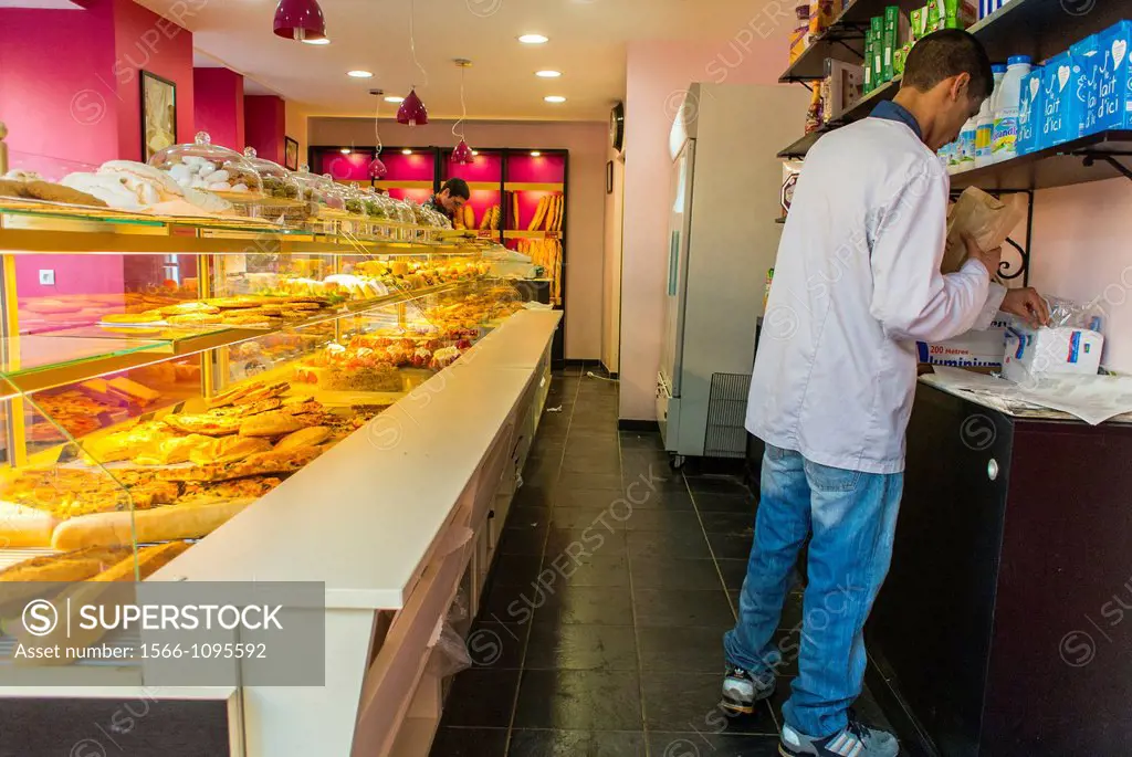 Paris, France, Clerk in Arab French Bakery Shop, Boulangerie, in Belleville Chinatown District