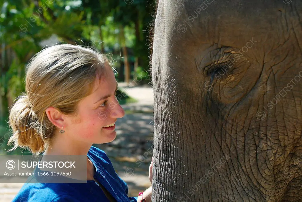 Young woman with elephant Mahout and Elephant Training School near Lampang, north Thailand