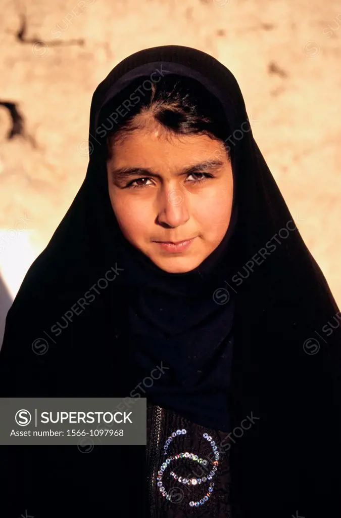 Portrait of young iranian girl in a black chador, Iran