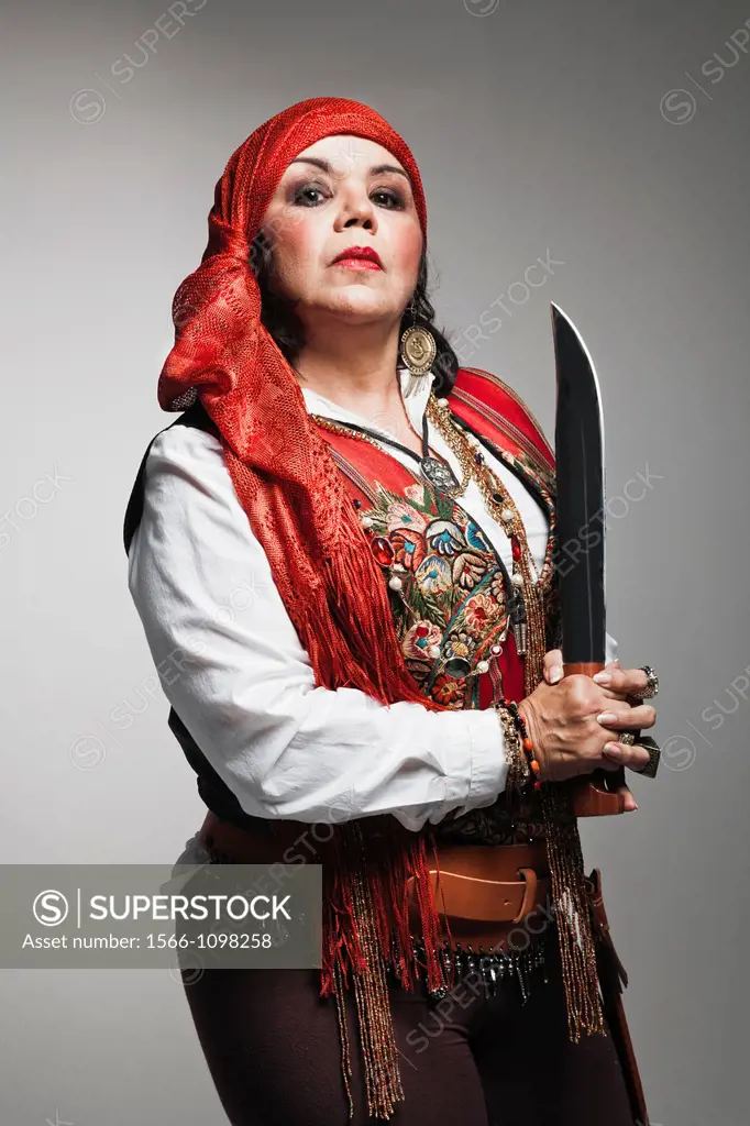 Mature woman with pirate costume holding a machete