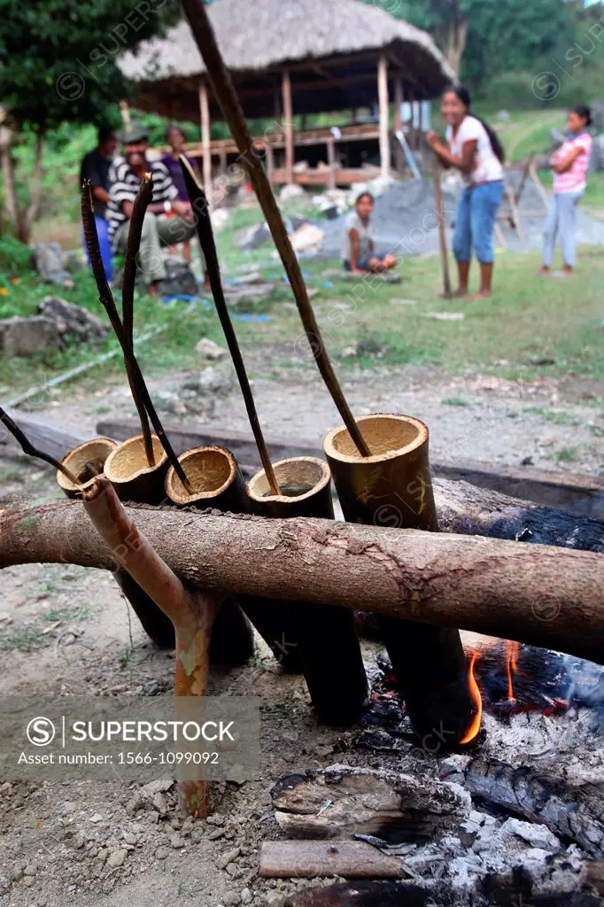 Timorese cooking on open fire  Loi Huno village, East Timor