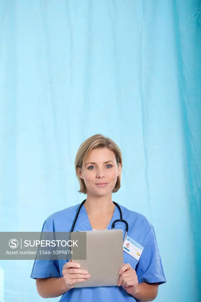 Female Nurse reviewing medical records on a tablet computer