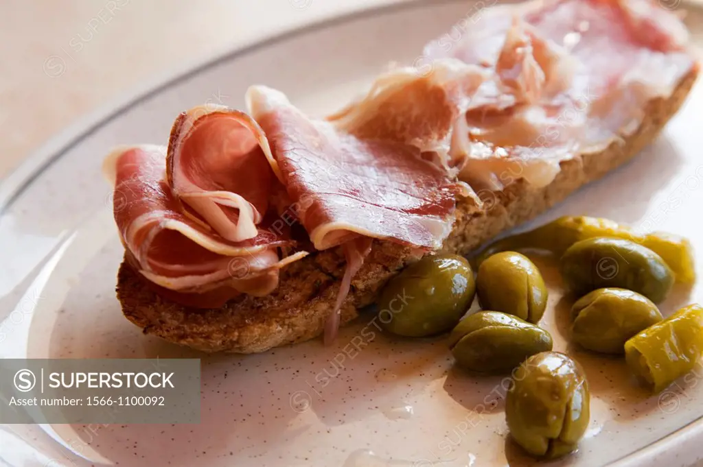 Ham Toast with olives. Spain