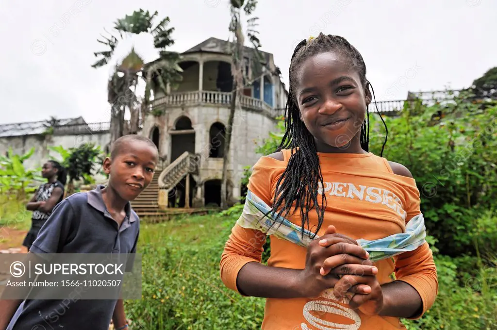 young girl in front of the former ruined hospital of the roca plantation Agua Ize, Sao Tome Island, Republic of Sao Tome and Principe, Africa.