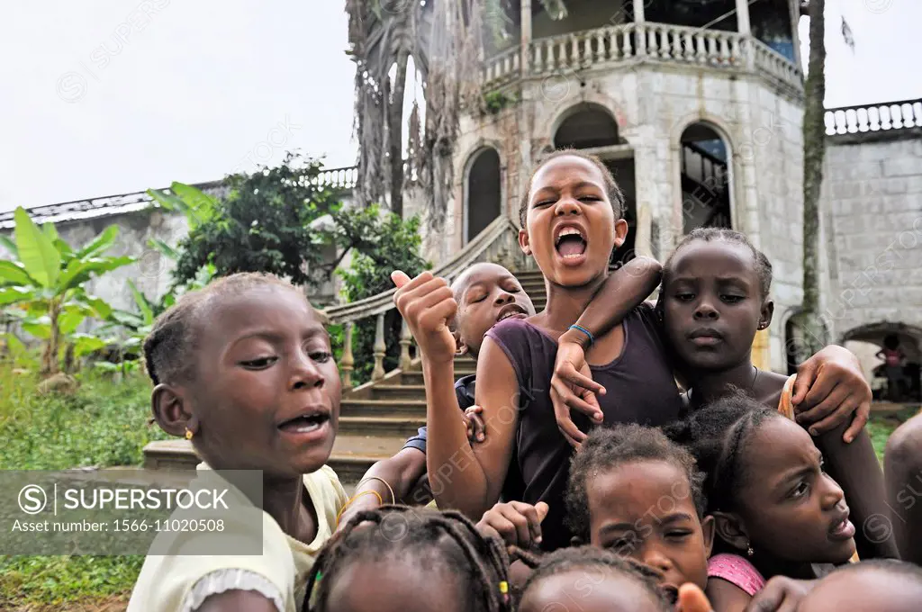 children in front of the former ruined hospital of the roca plantation Agua Ize, Sao Tome Island, Republic of Sao Tome and Principe, Africa.