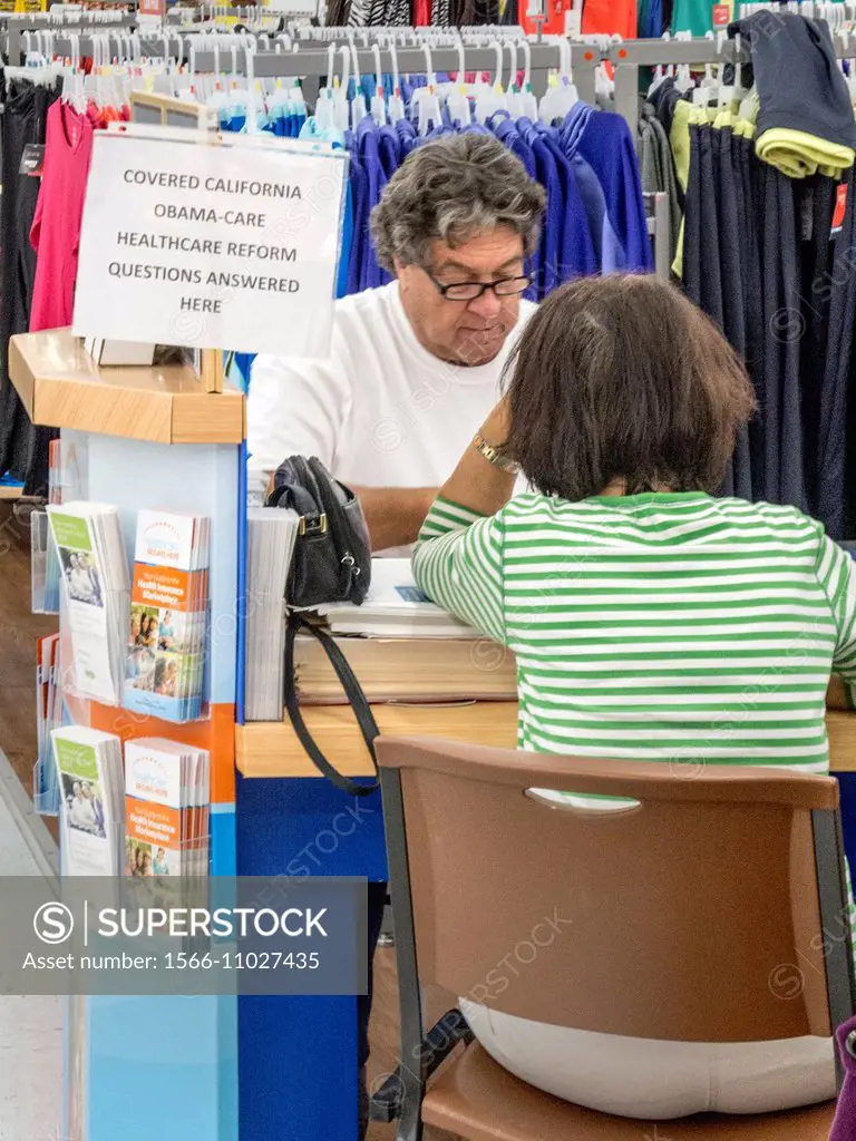 An insurance agent mans a sales kiosk at a Laguna Niguel, CA, discount clothing store offering coverage under the Affordable Healthcare Act or Obamaca...