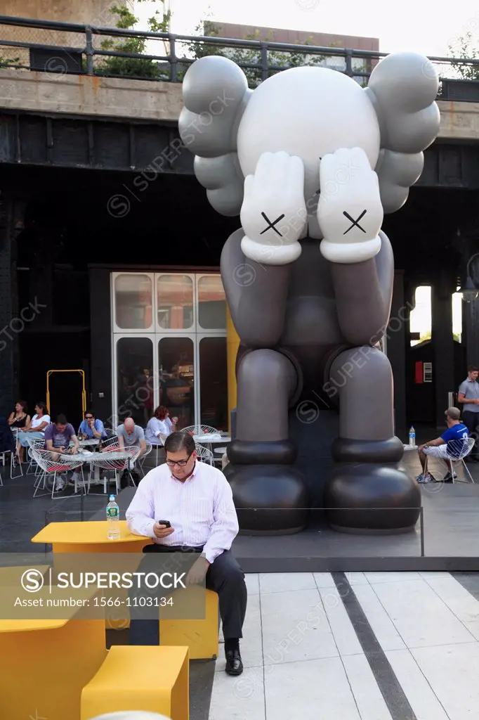 The statue of KAWS: Passing Through display in the front yard of the Standard Hotel in Meatpacking District  Manhattan  New York City  USA.