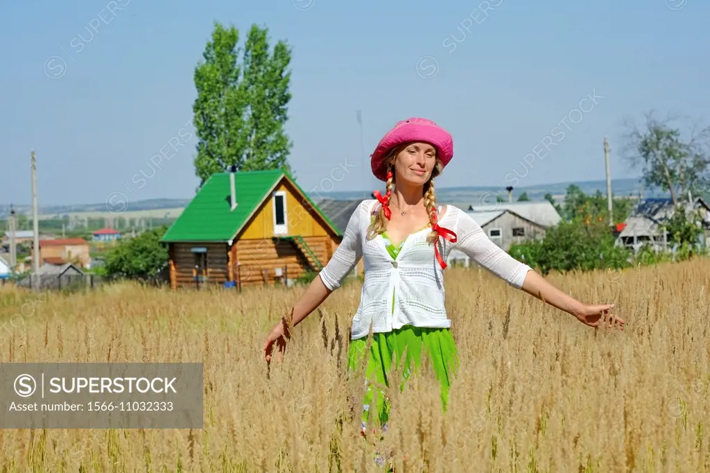 Woman and traditional russian house, Kuz´kino, Russian Federation
