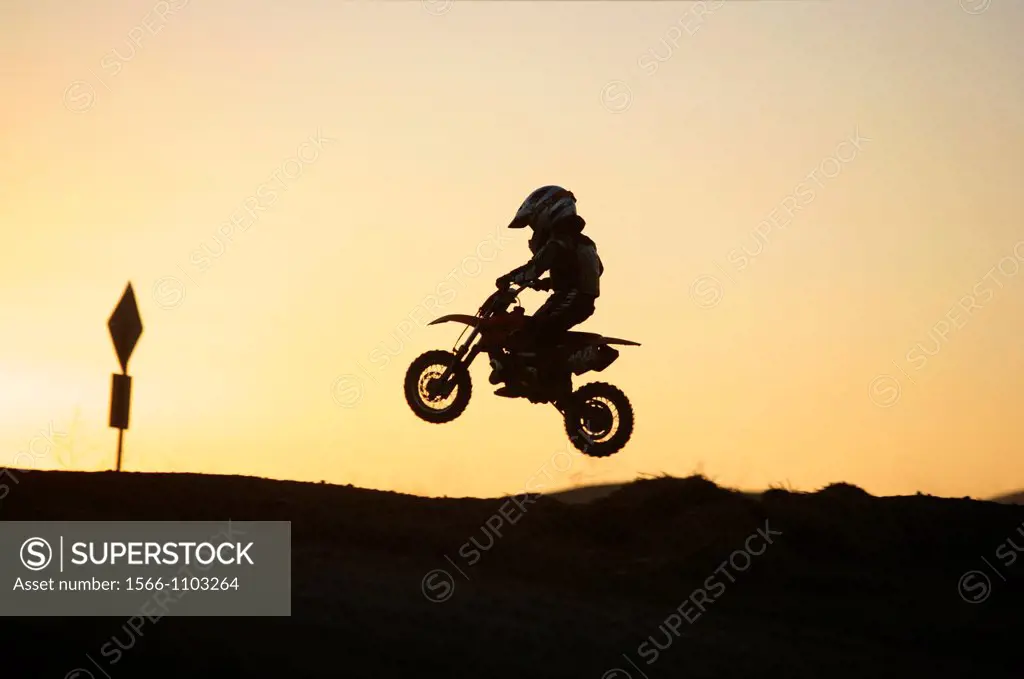 Young child learning the ropes of motocross riding in California, USA