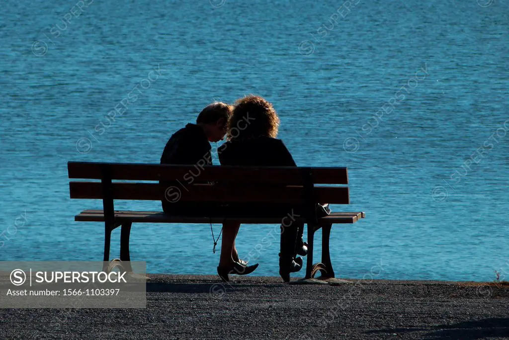Two friends share a quiet moment by the seaside in Meze, France