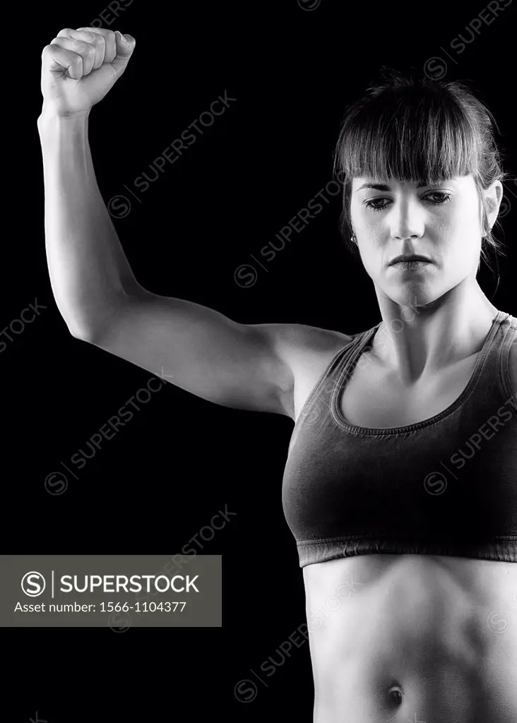 Athletic young woman practicing martial arts