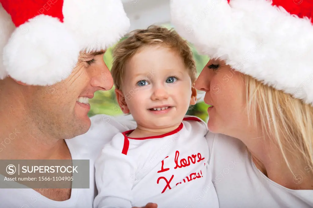 Parents with their one year old son at Christmas time