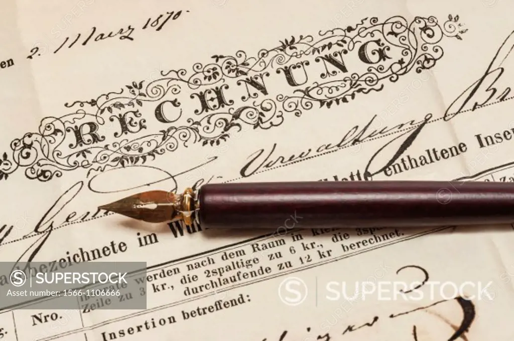 Detail photo of a old German invoice from the year 1870, a fountain pen is alongside