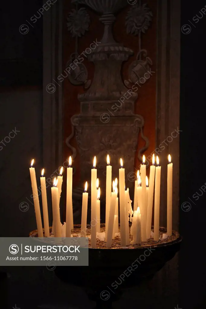 Many candles inside santa maria in trastevere church in Rome Italy