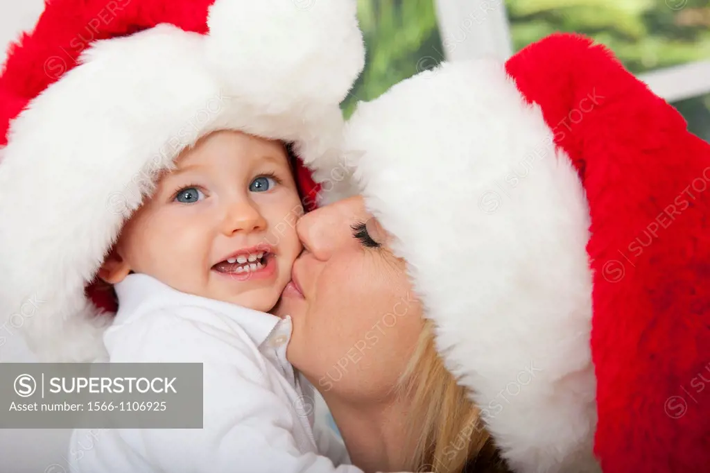 Mother and child wearing Santa hats