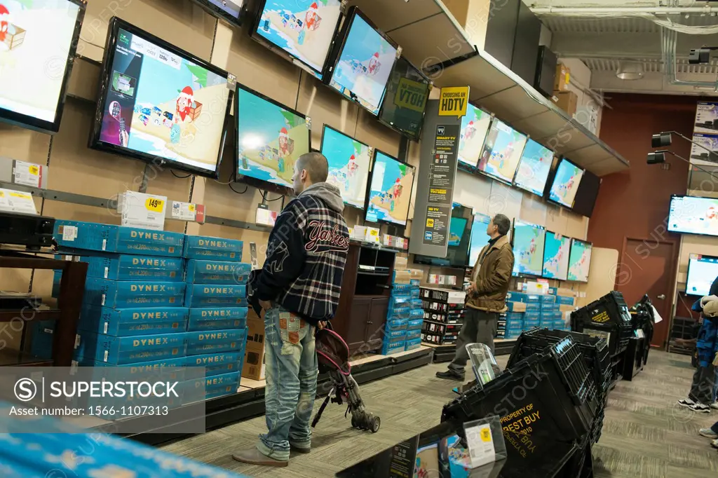 Shoppers browse flat-screen televisions in a Best Buy in the Elmhurst neighborhood in the borough of Queens in New York over the Black Friday weekend,...