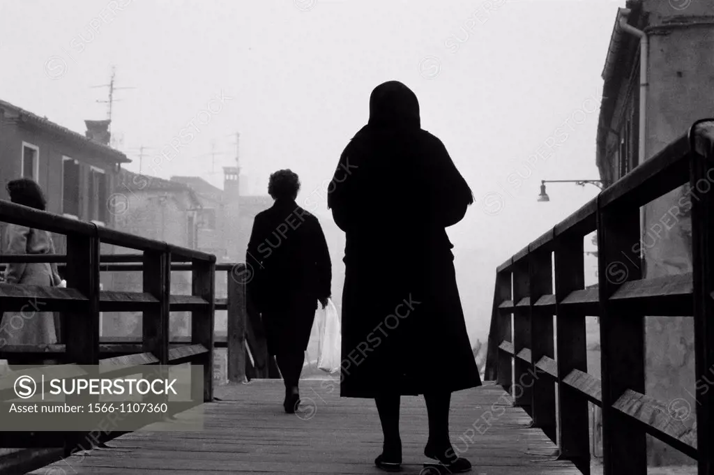 Elder women dressed in black in the island of Burano, Venice lagoon, Venice, Italy, Europe