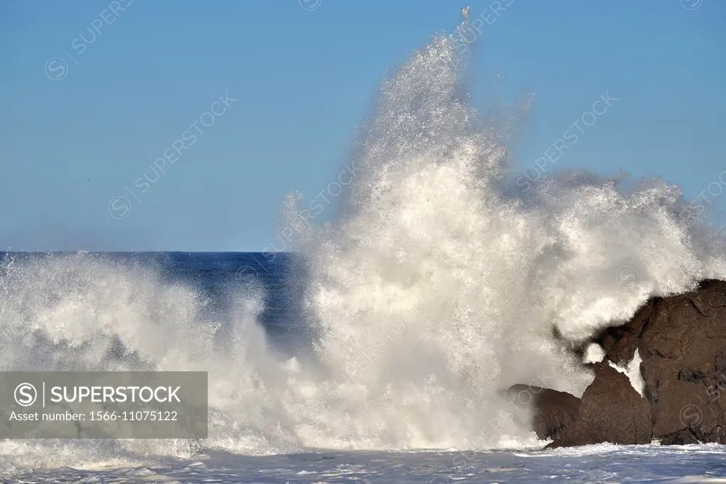 Big wave breaking against a rock