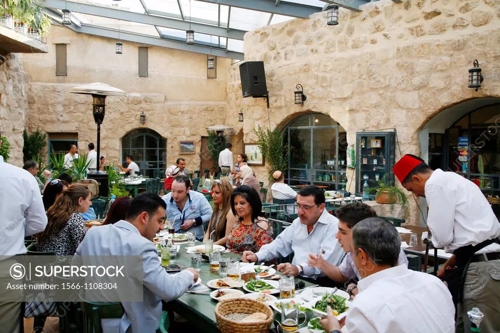 People in a restaurant at the restored Haret Jdouna house, Jordan