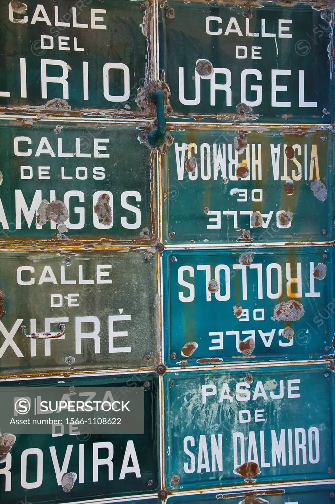 Collection of street signs in a door in Porrera, Priorat, Tarragona, Spain, Europe