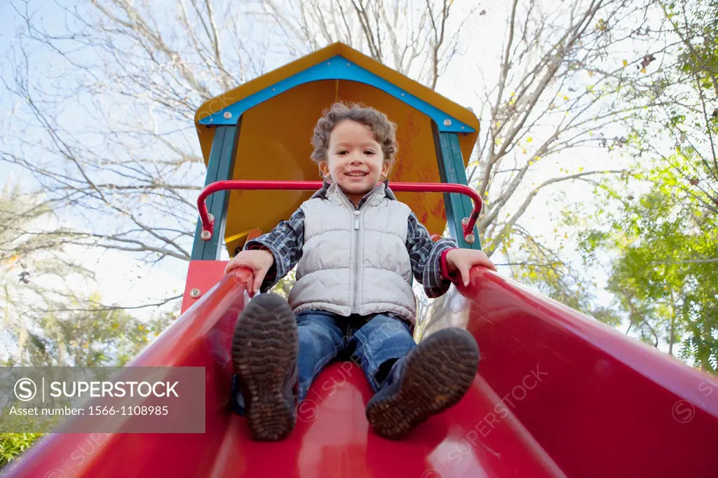 3 year old boy playing in a playground