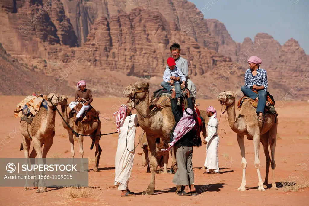 Tourists riding camels in the desert, Wadi Rum, Jordan