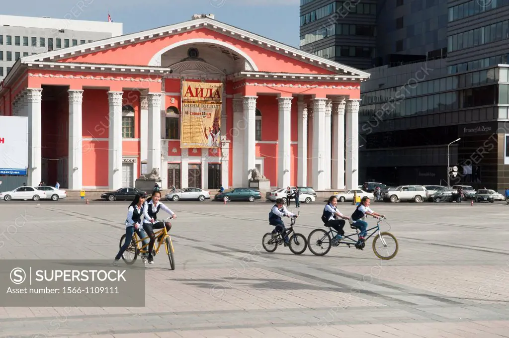 riding bicycles in front of the opera house in Ulan Baatar, Mongolia