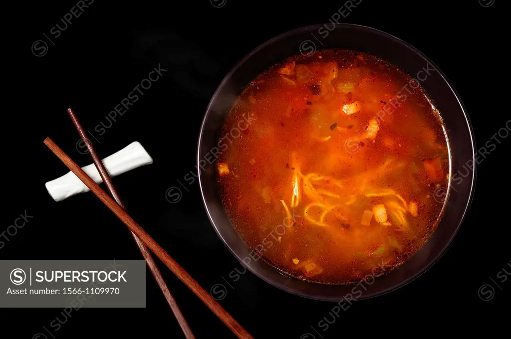 Close up of a bowl of Chinese style noodle soup on black background