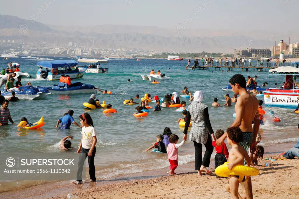 People on the public beach of Aqaba, Jordan