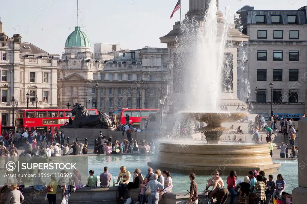 People relaxing by a Fountain of Trafalgar Square, London, England, UK