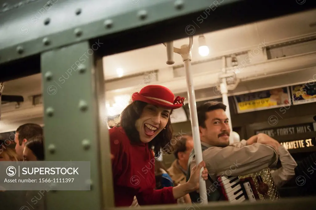 New Yorkers, tourists and subway buffs, some in period garb, travel on a vintage MTA Nostalgia Train Christmas season ride The straps, ceiling fans an...
