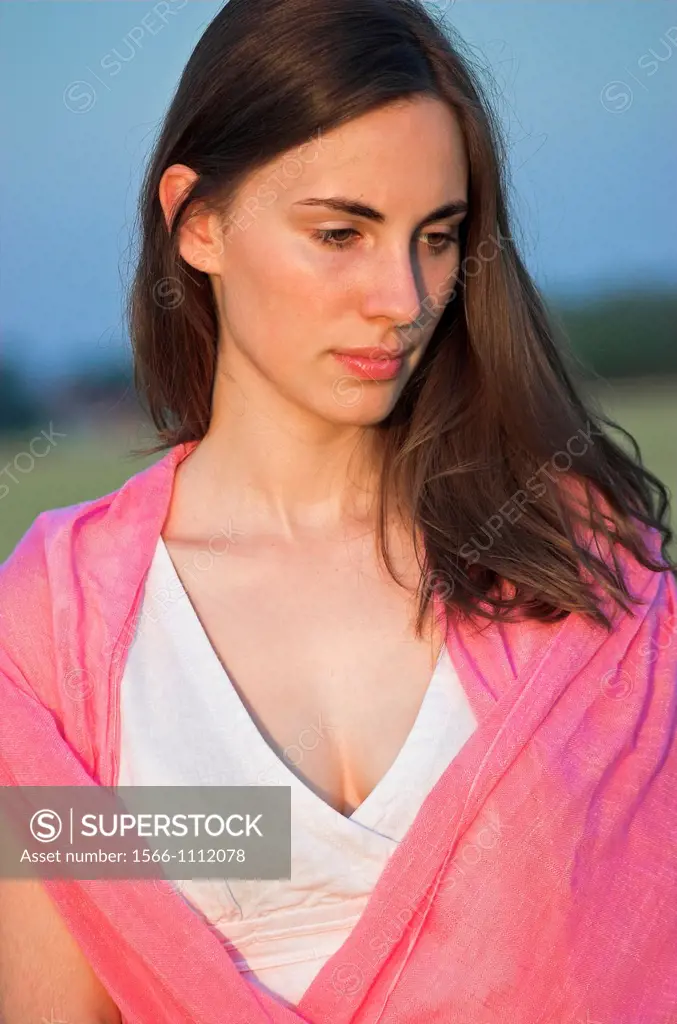 Portrait of a beautiful young woman outdoors looking down