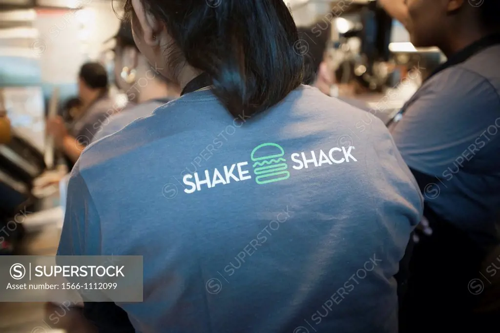 Employees hustle to fill and serve orders at the grand opening of the Shake Shack in Downtown Brooklyn in New York The popular restaurant, run by note...