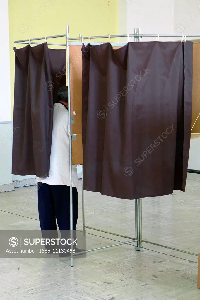 A man votes in a booth on voting day