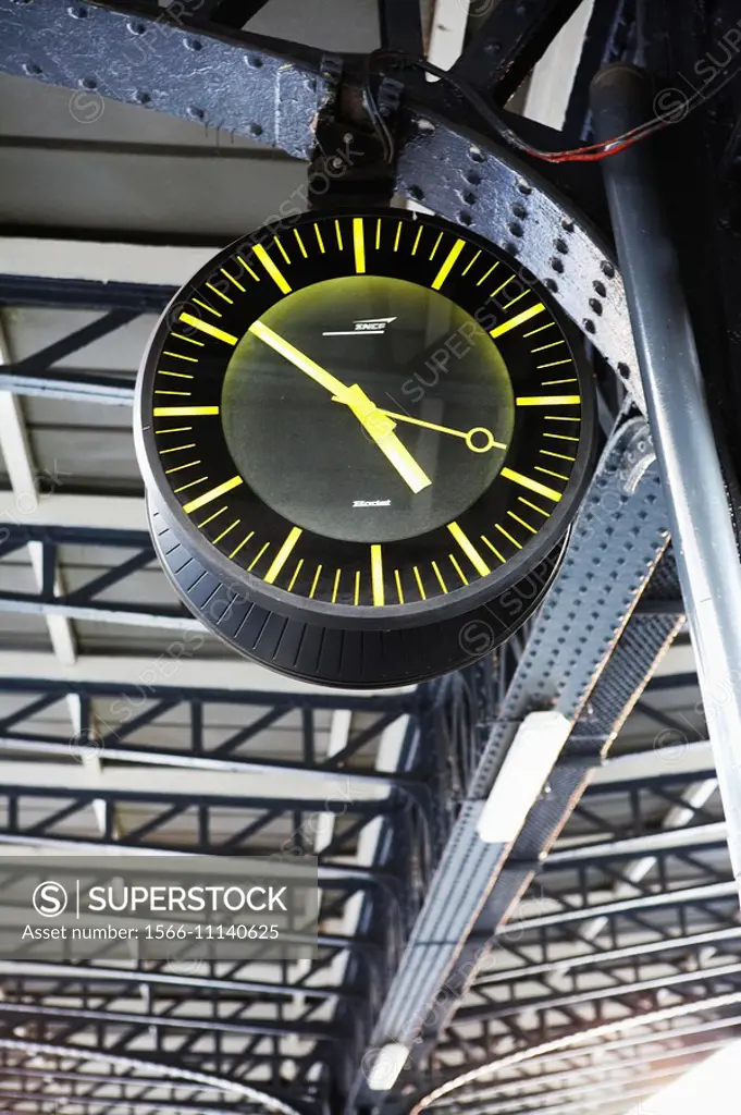 Clock on the platform of the station is in Paris