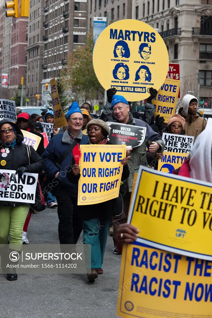 Activist members of the NAACP and unions march and rally, starting at the offices of Koch Industries, in New York on Human Rights Day, against the imp...