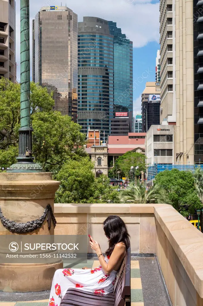 Australia, Queensland, Brisbane, Central, Business, District, CBD, Ann Street, woman, public bench, city skyline, skyscrapers, office buildings.