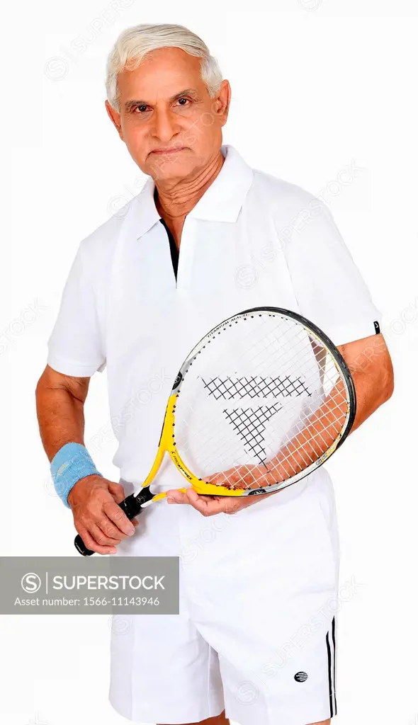 Middle aged man with tennis racquet in hand, Pune, India.