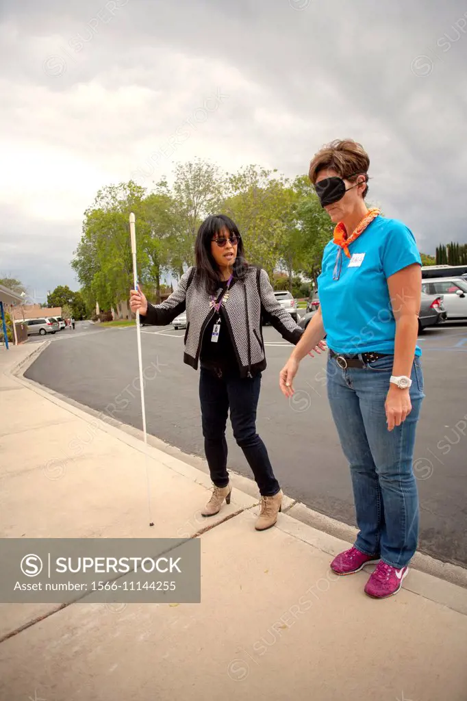 Visitors to a school for the blind in Tustin, CA, are blindfolded to allow them to experience sightlessness as they learn to use a white cane for walk...