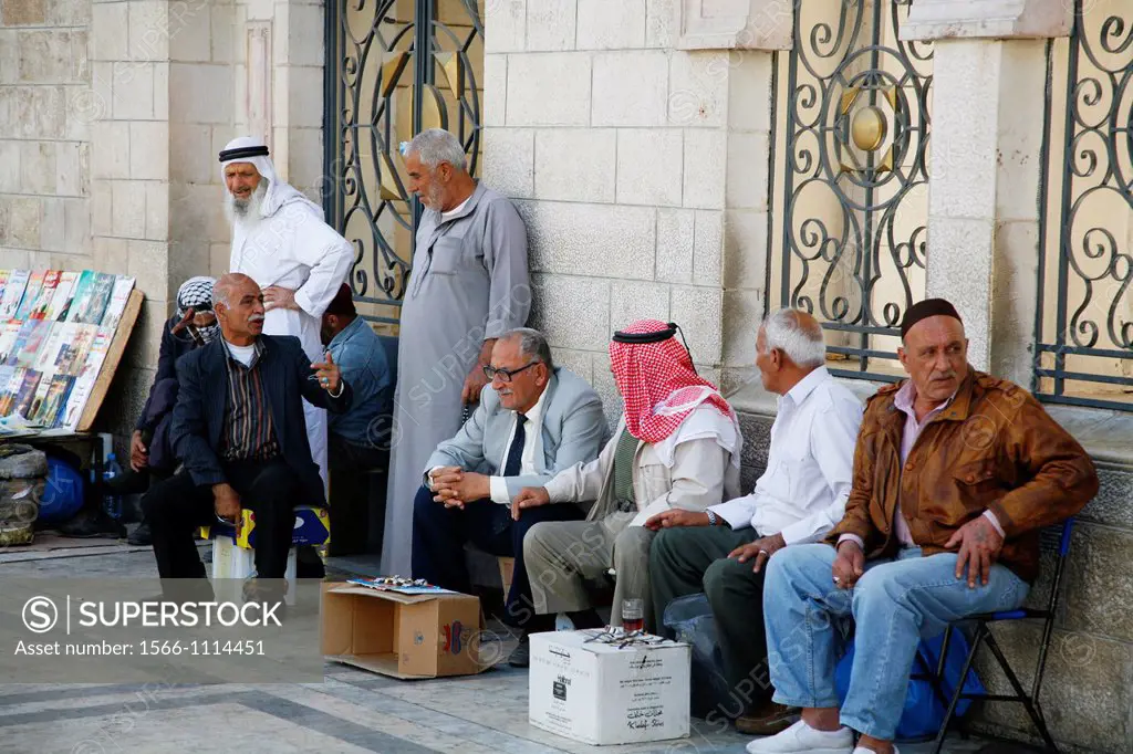 Men outside the Al Husseiny mosque in downtown Amman, Jordan