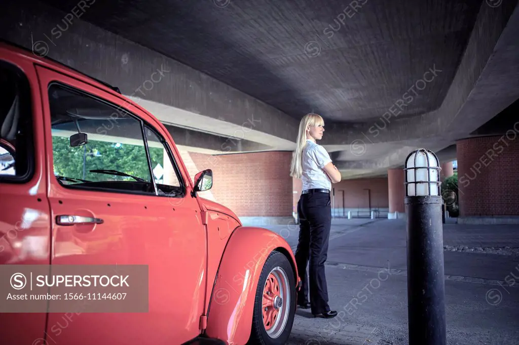 urban portrait of a young woman with a classic car.